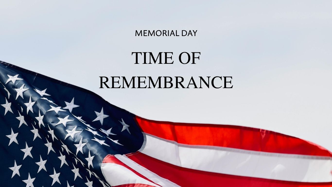 American flag waving in the breeze with the caption 'MEMORIAL DAY TIME OF REMEMBRANCE'.